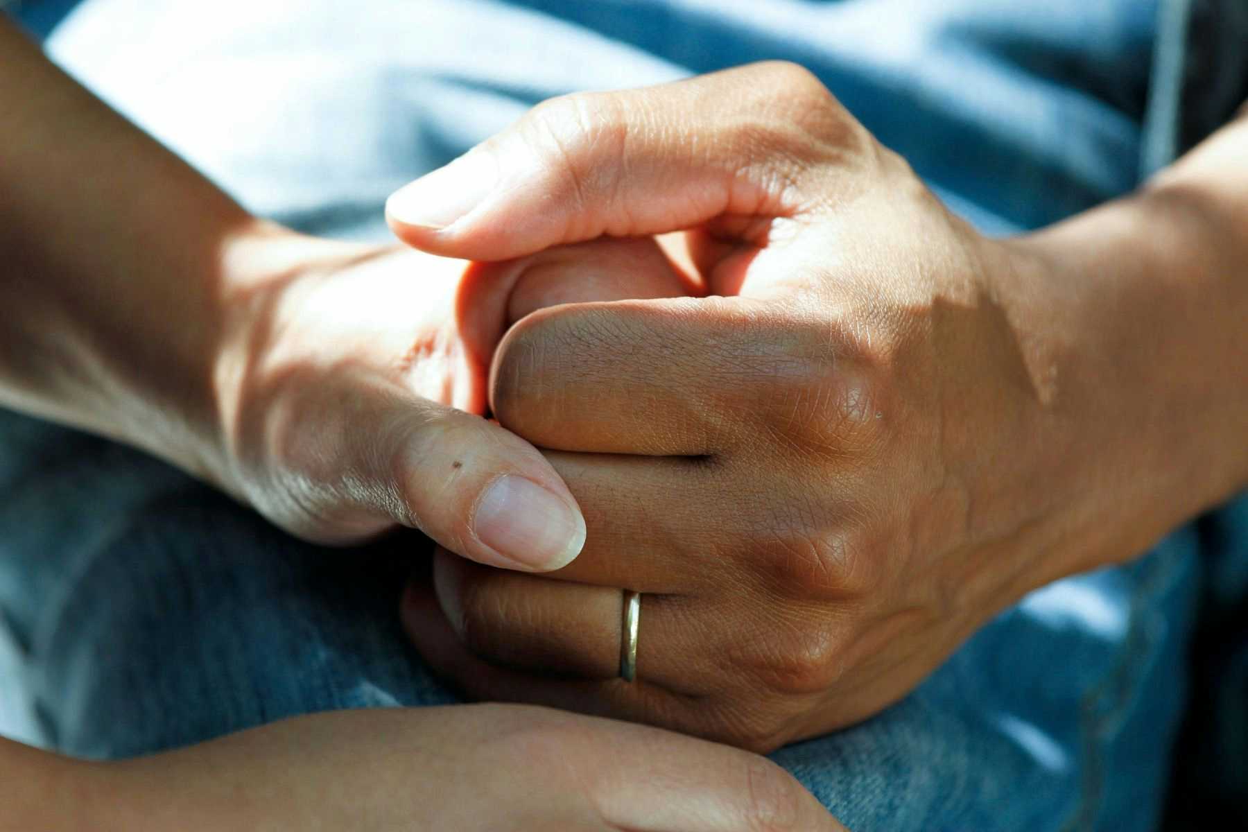Elderly patient holding a hand