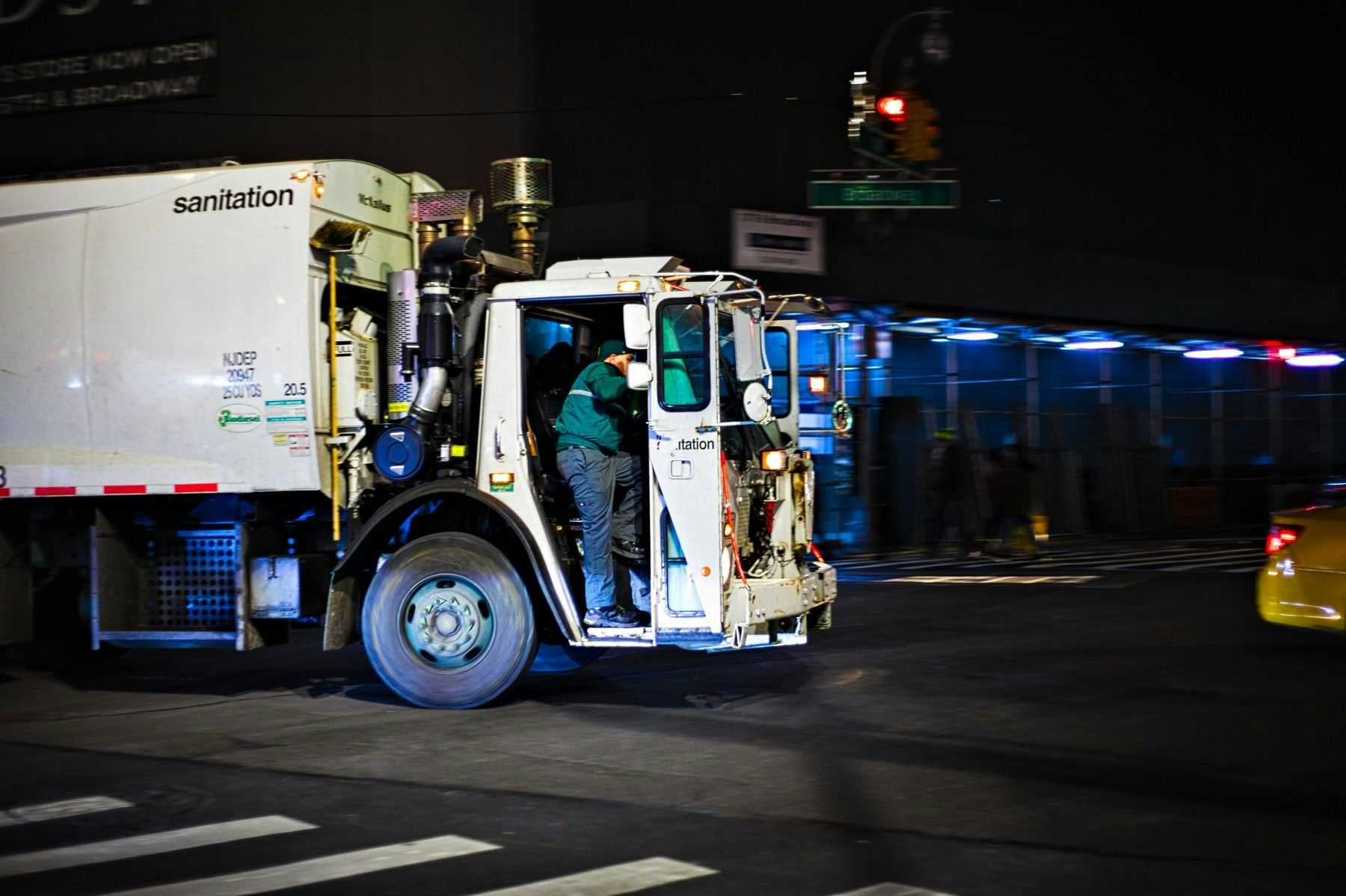Sanitation ruck going through New York City intersection