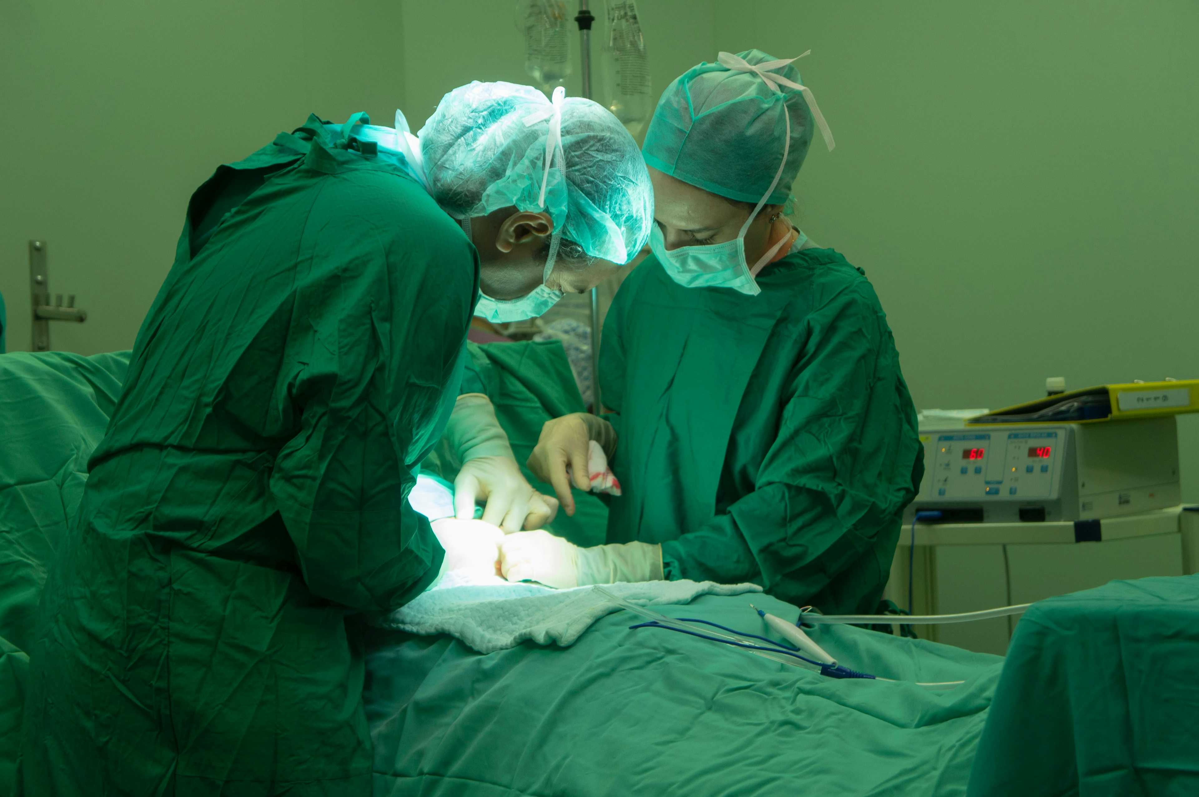 Doctors performing c section surgery