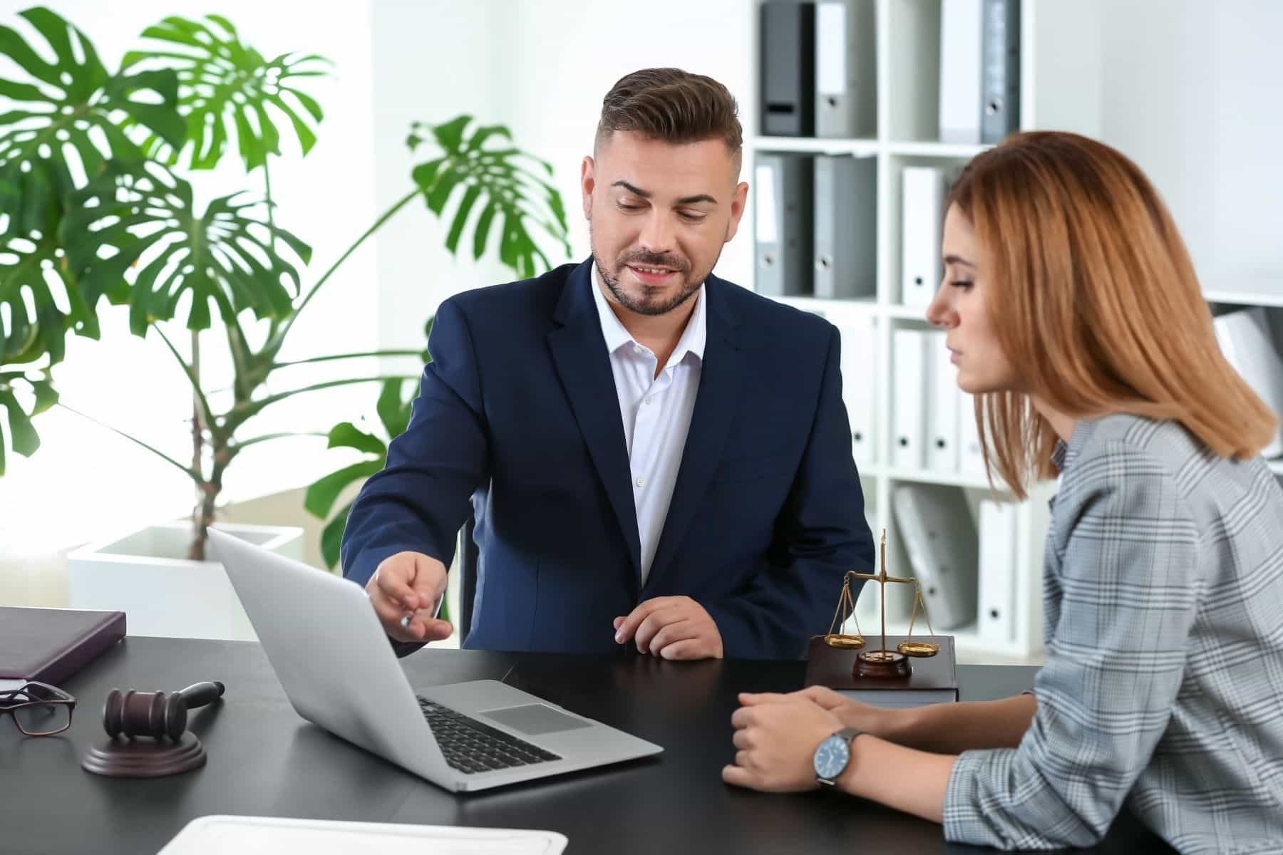 Attorney showing laptop to client