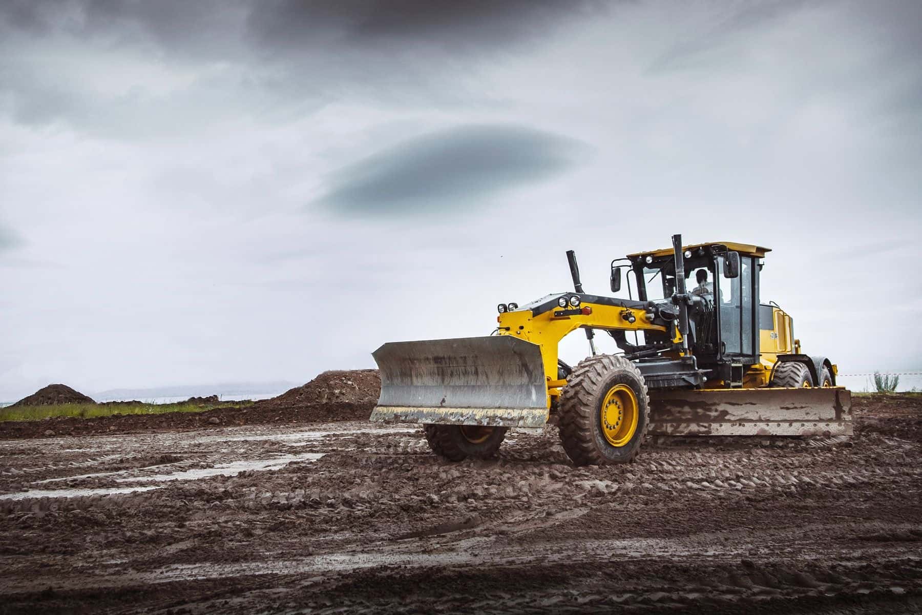 Road grader heavy earth moving on farm land