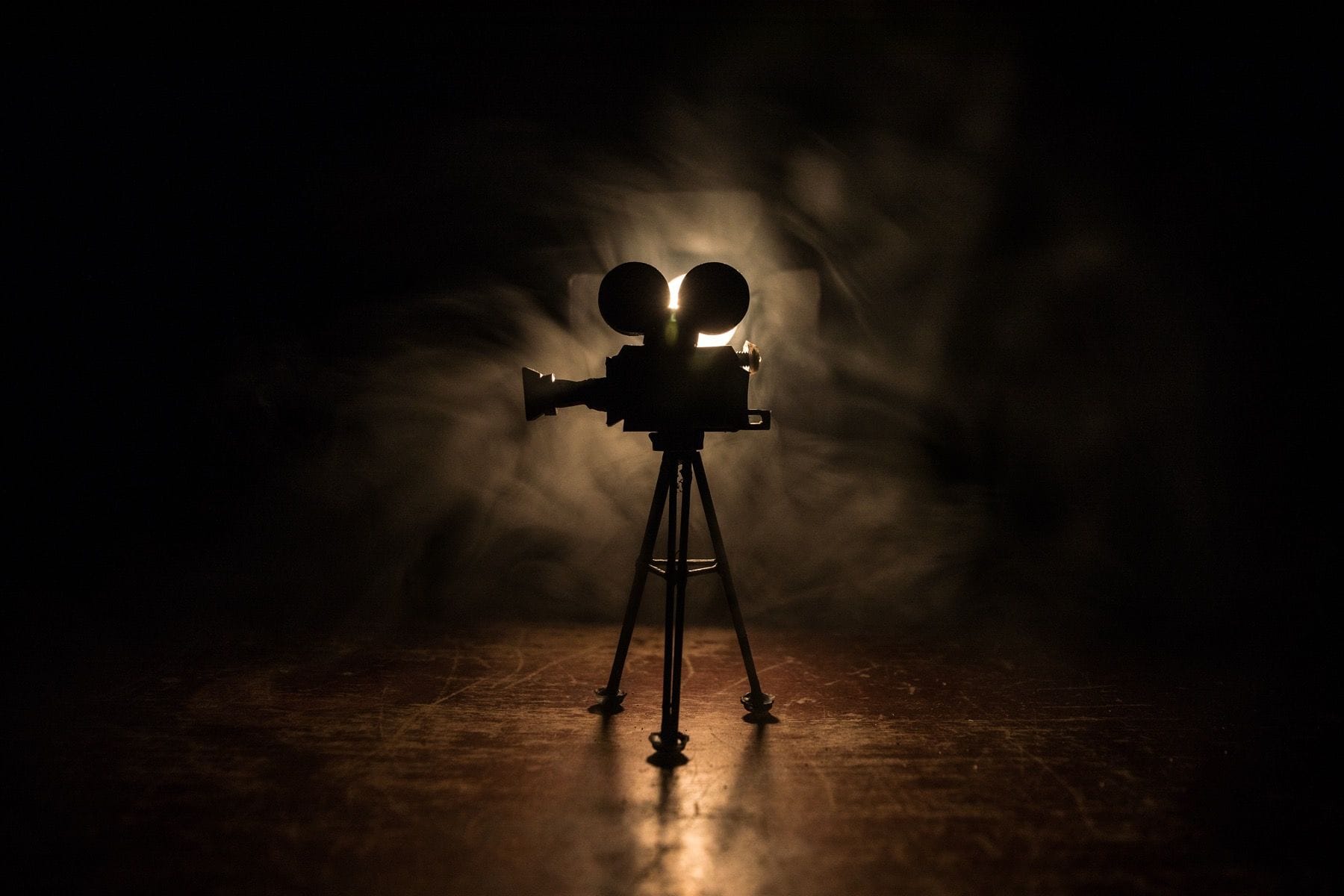 Silhouette of vintage camera on tripod