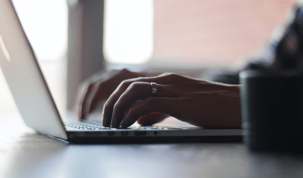 person typing on laptop to speed up case timeline