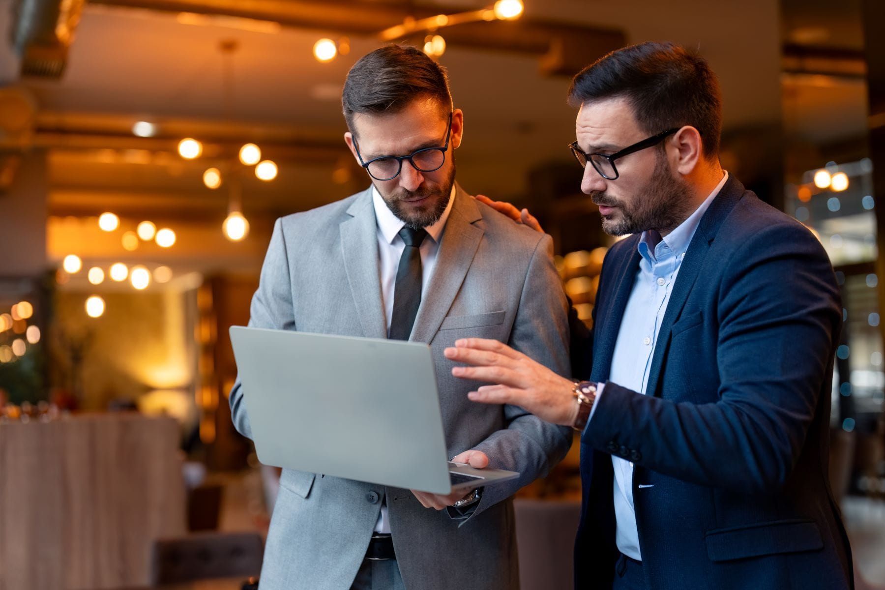 Two people working on a laptop computer