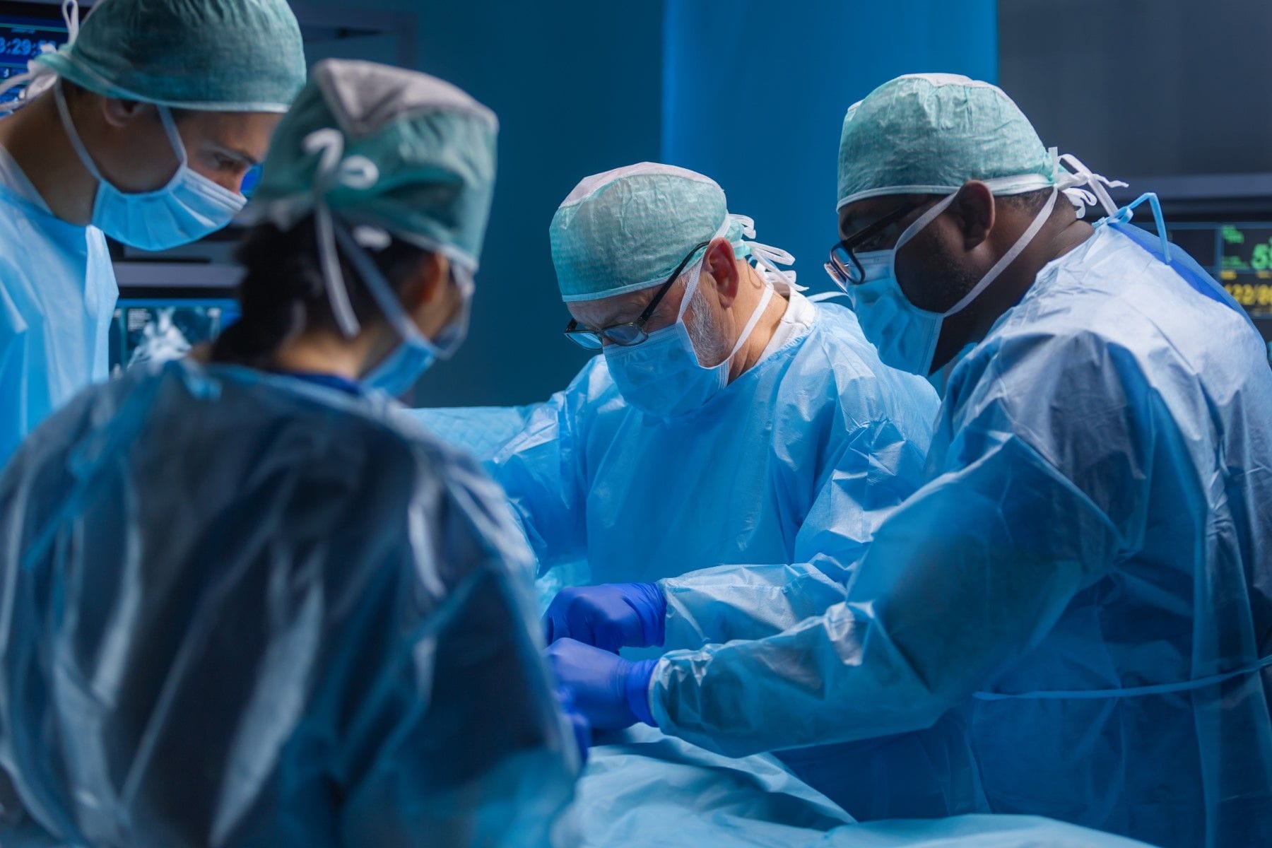 Group of surgeons operating