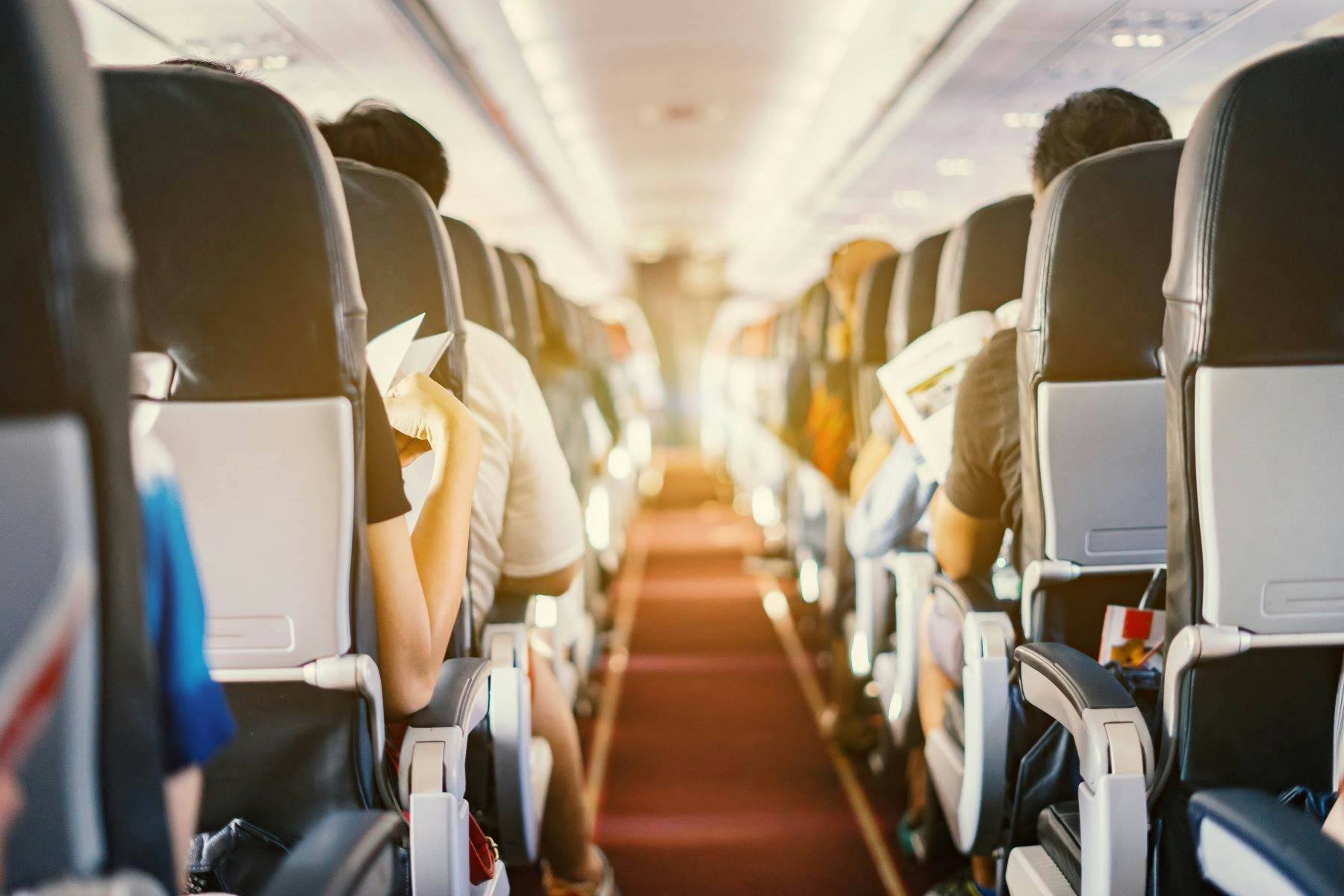Passengers sitting in airplane cabin