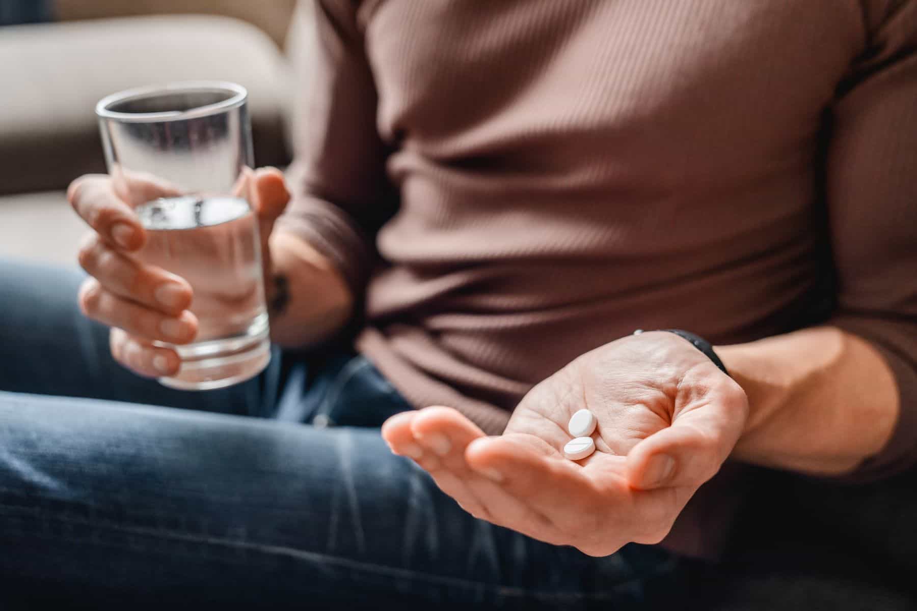 Person holding pills