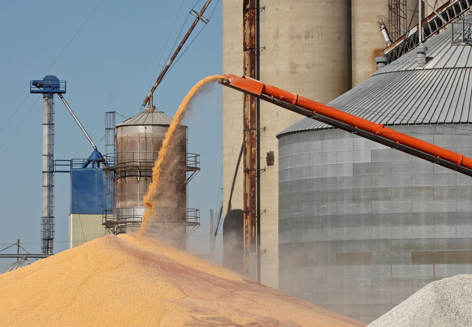 Grain auger unloading corn at a commercial silo site