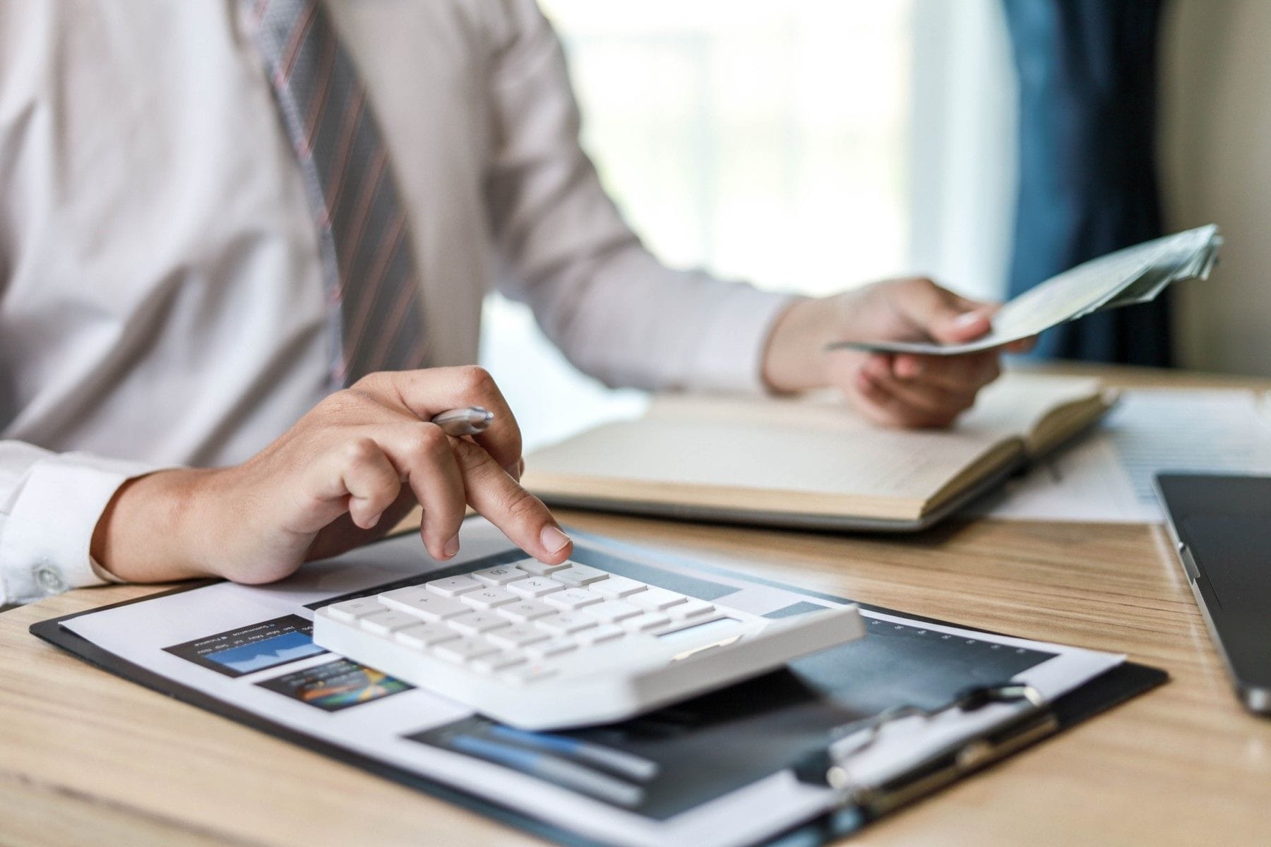 Person using calculator at desk