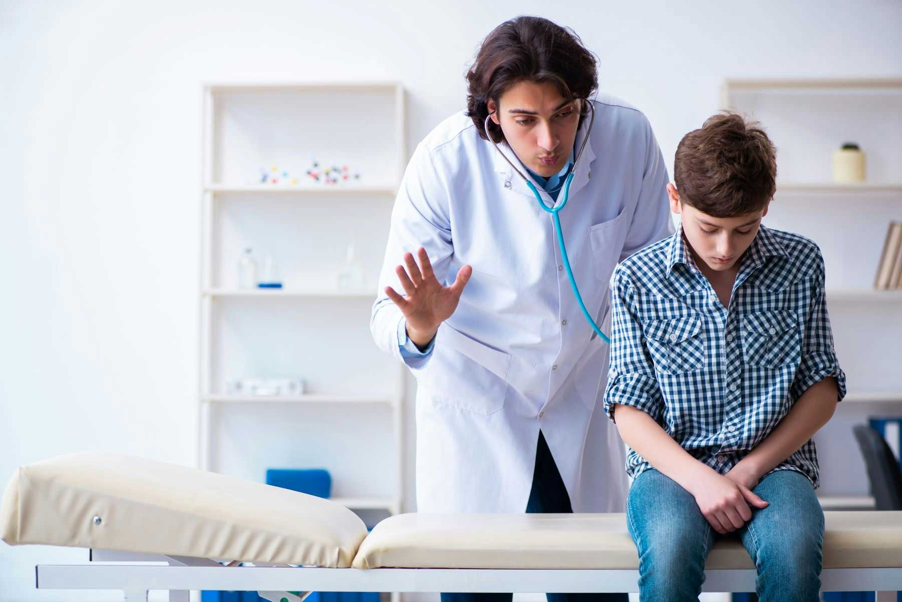 Urologist with adolescent boy