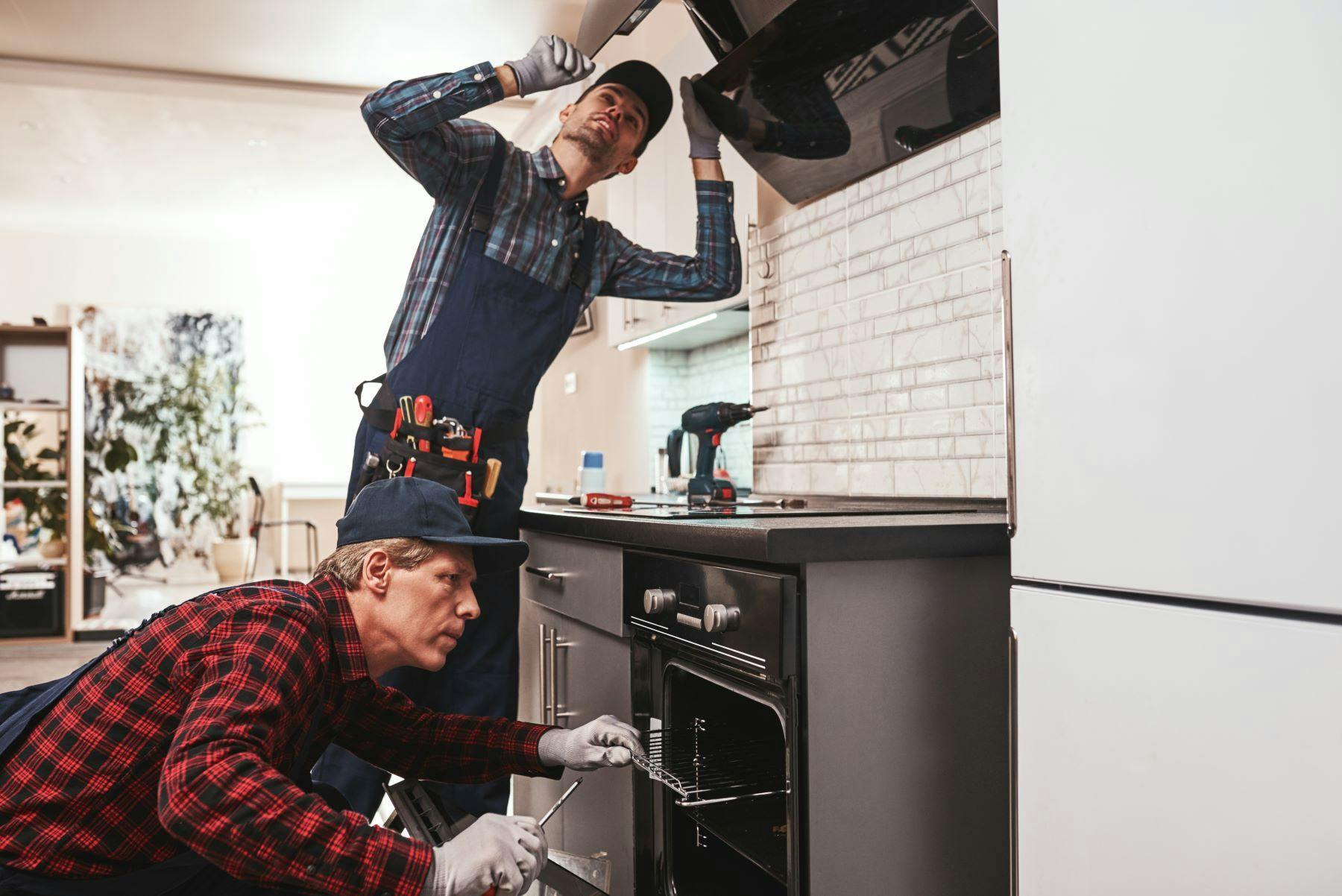 Electricians inspecting appliances