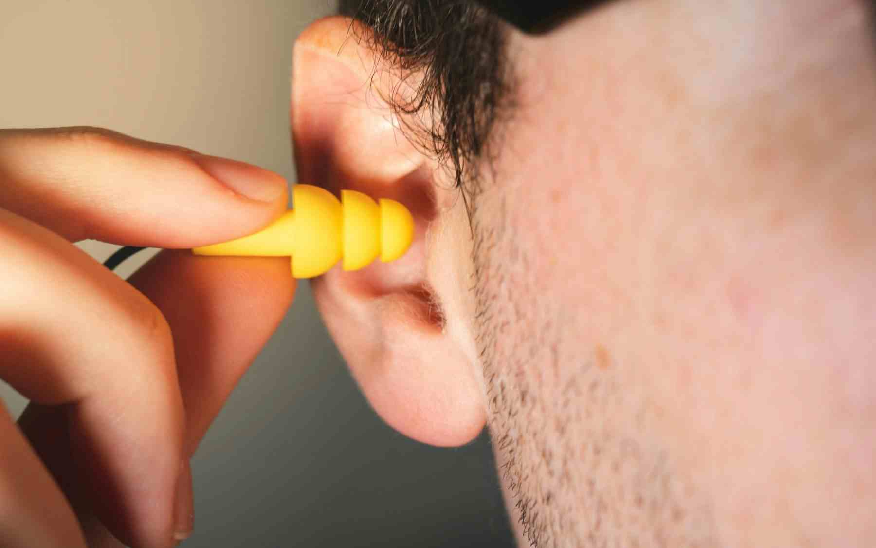 Person putting in an earplug