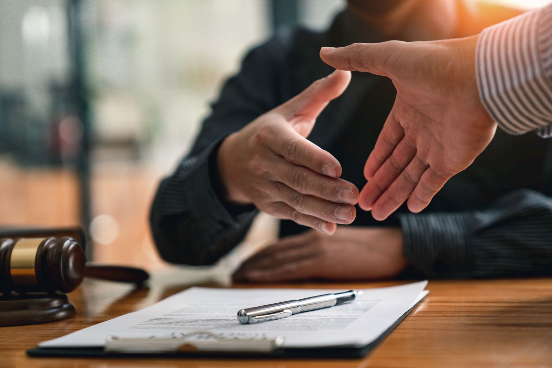 Business people shaking hands over contract