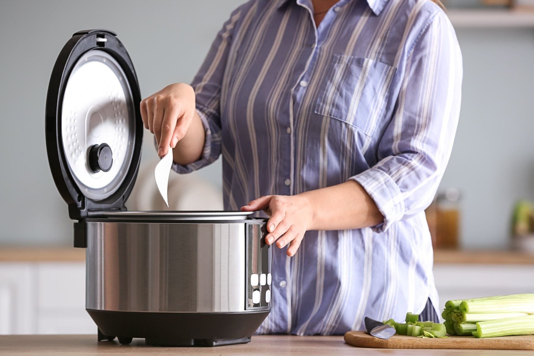 person using slow cooker