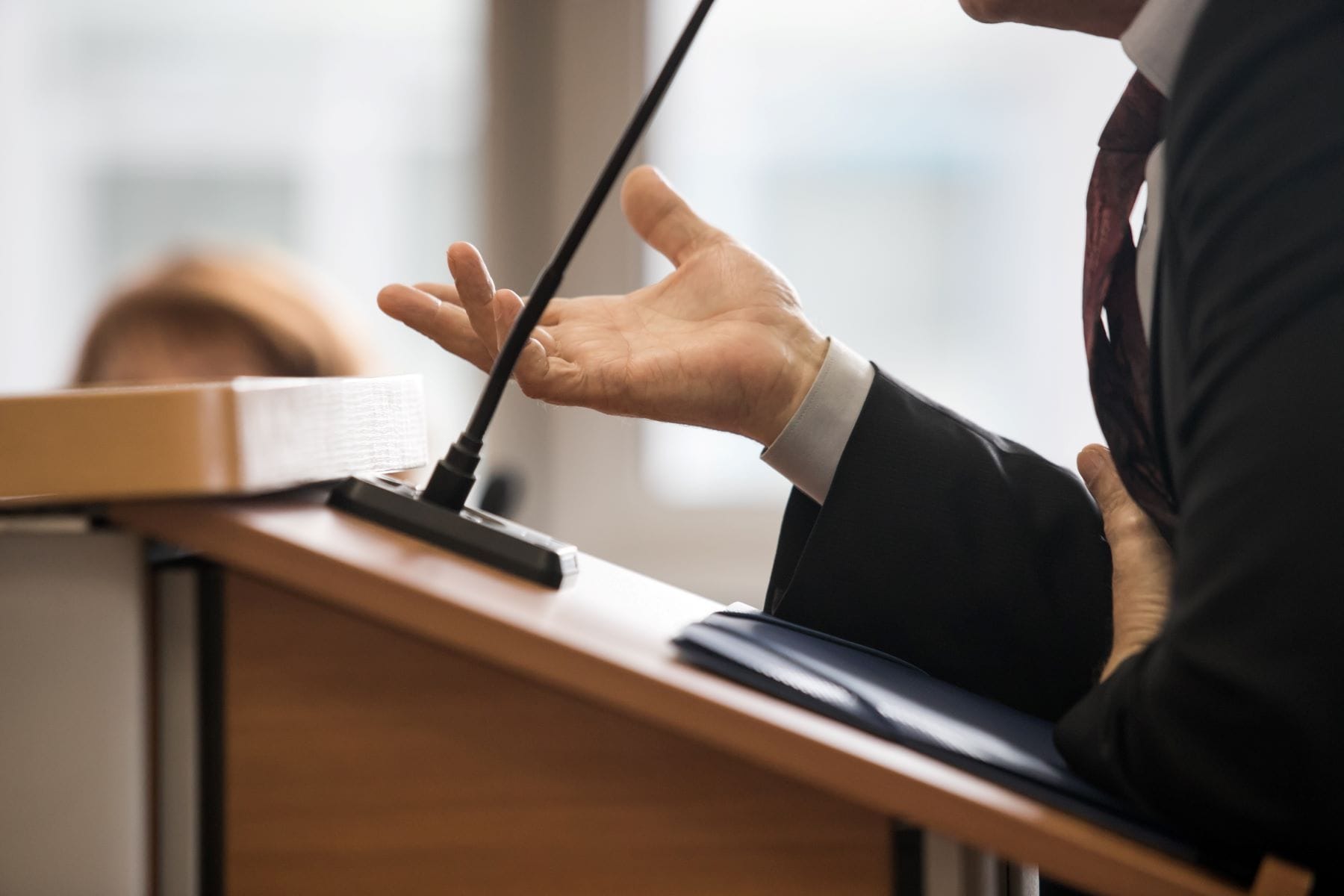 Expert witness speaking at a podium