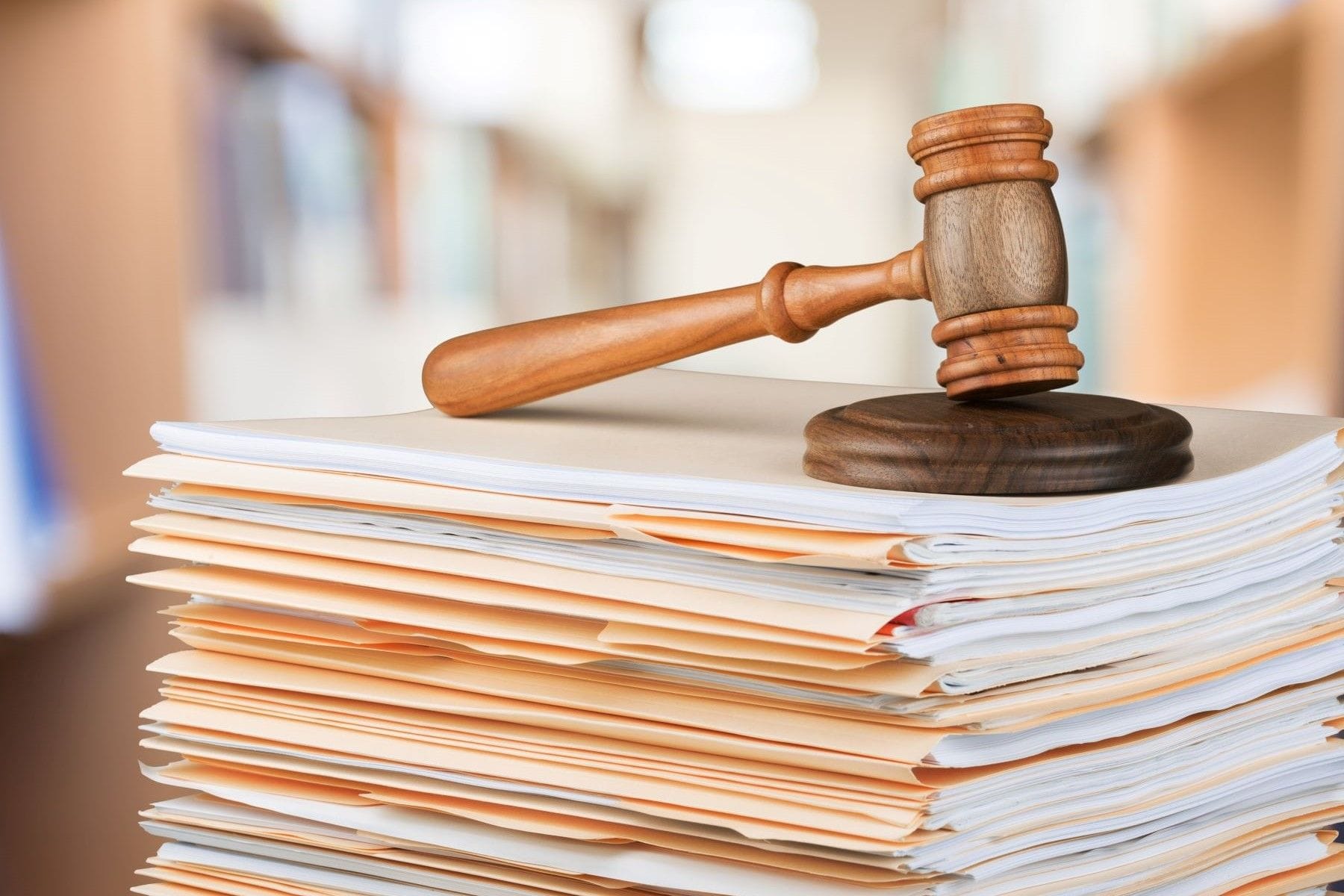 Gavel resting on a stack of legal files