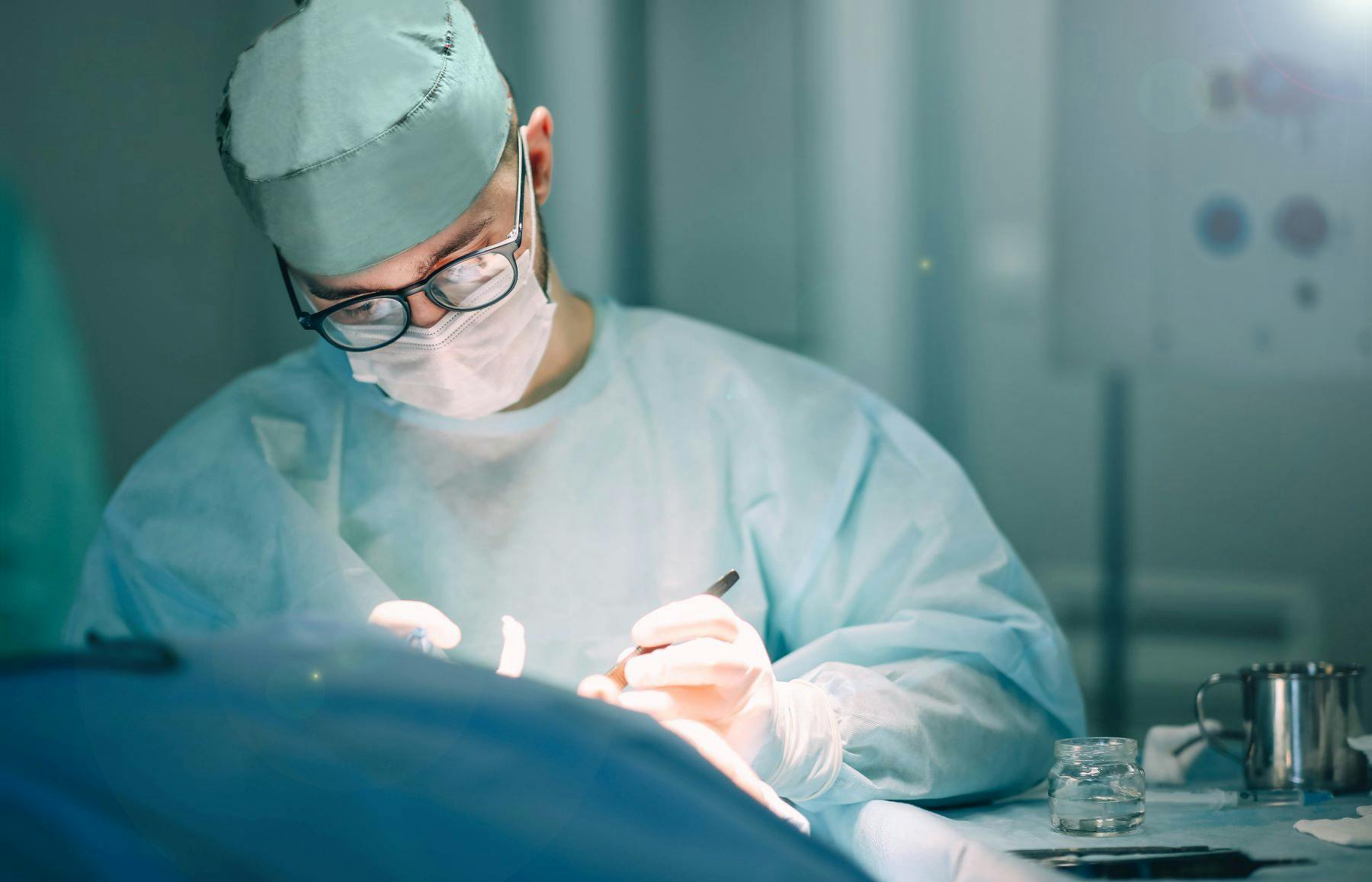 Surgeon operating on patient