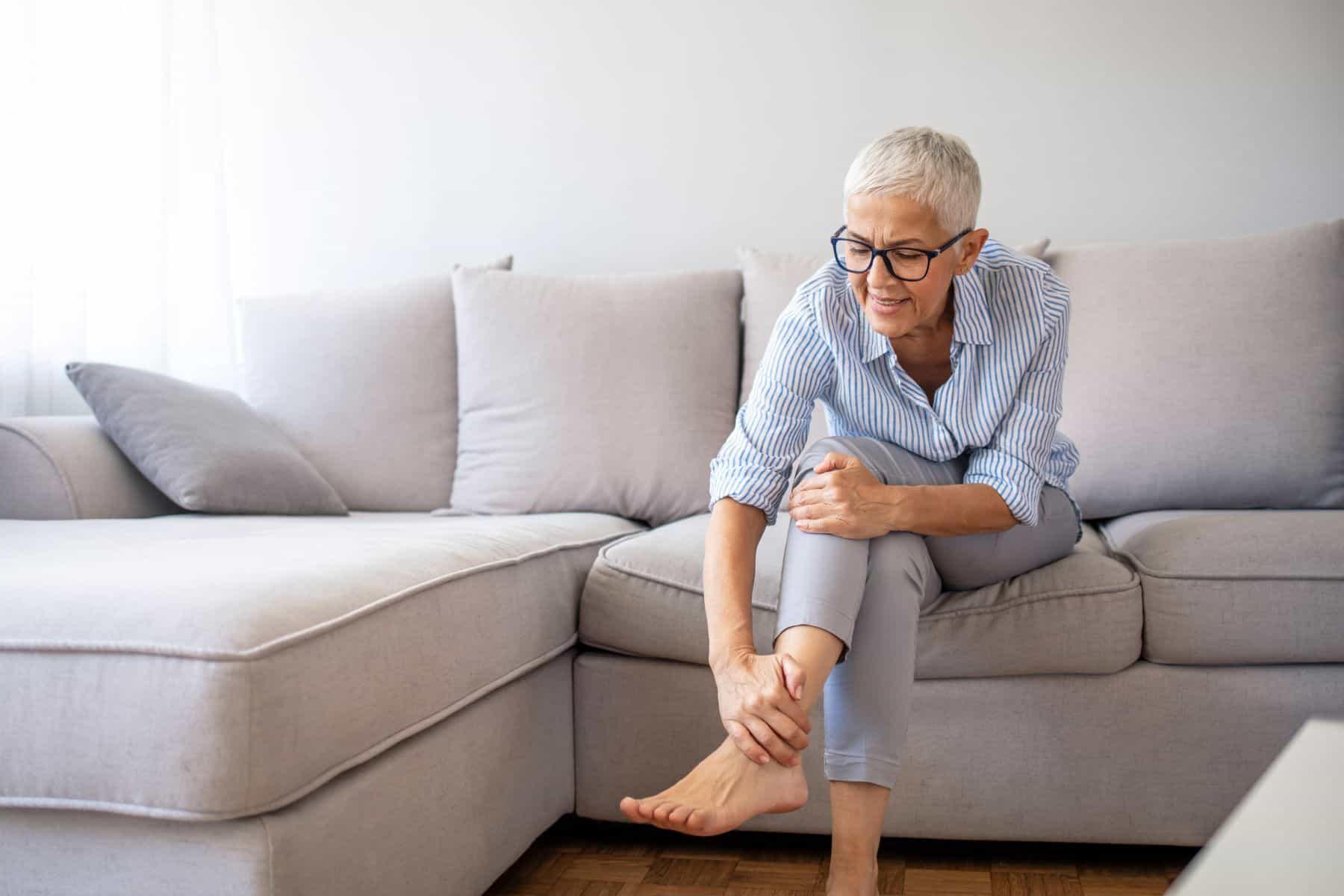 Woman holding painful foot