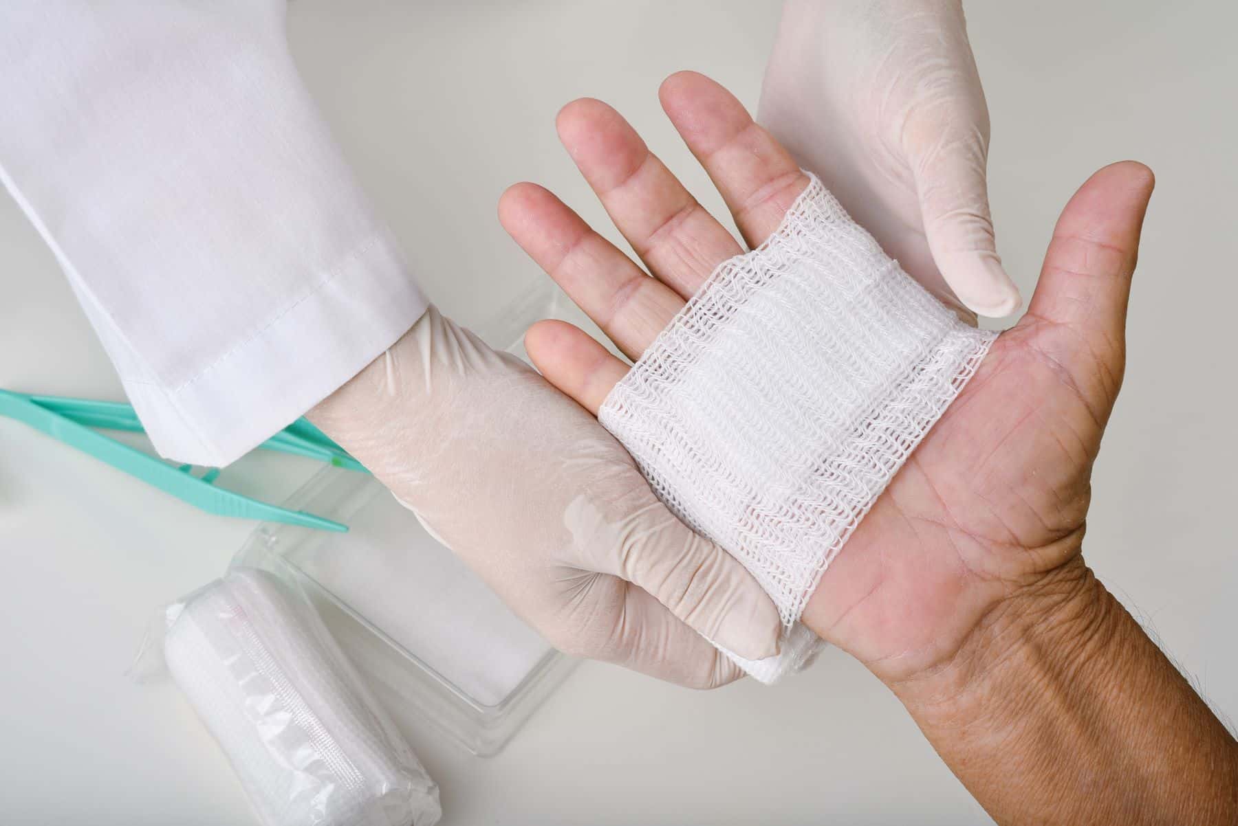 Hand being wrapped with bandage