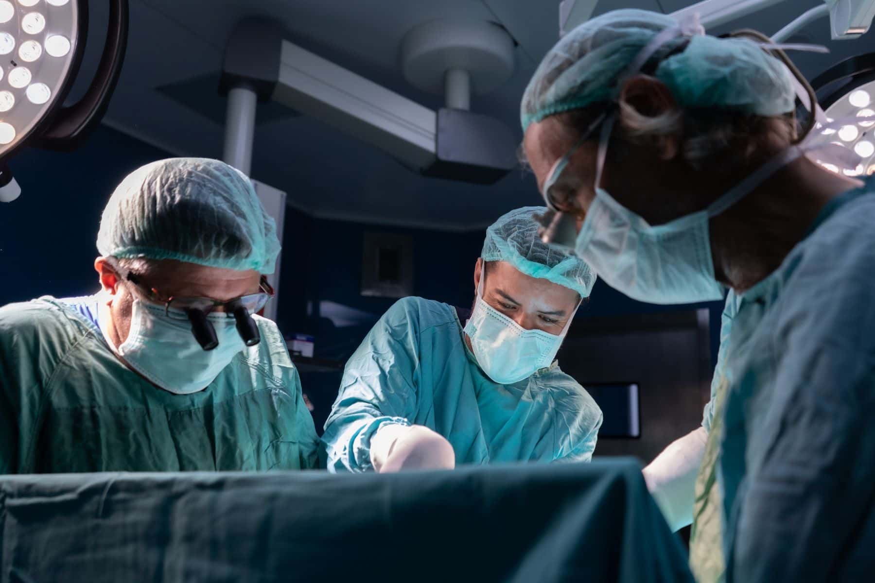 Surgeons operating on patient