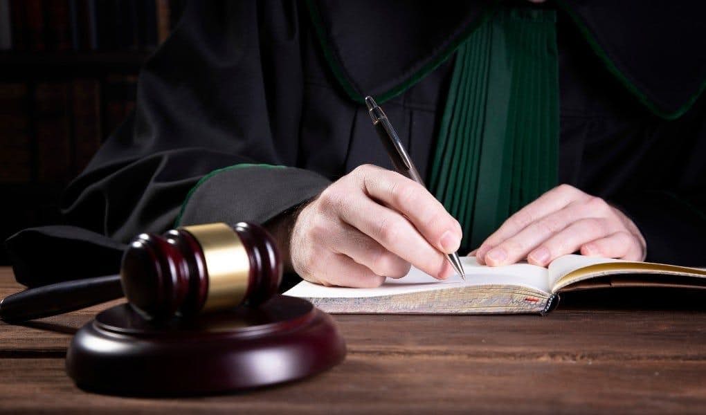 judge writing next to the gavel