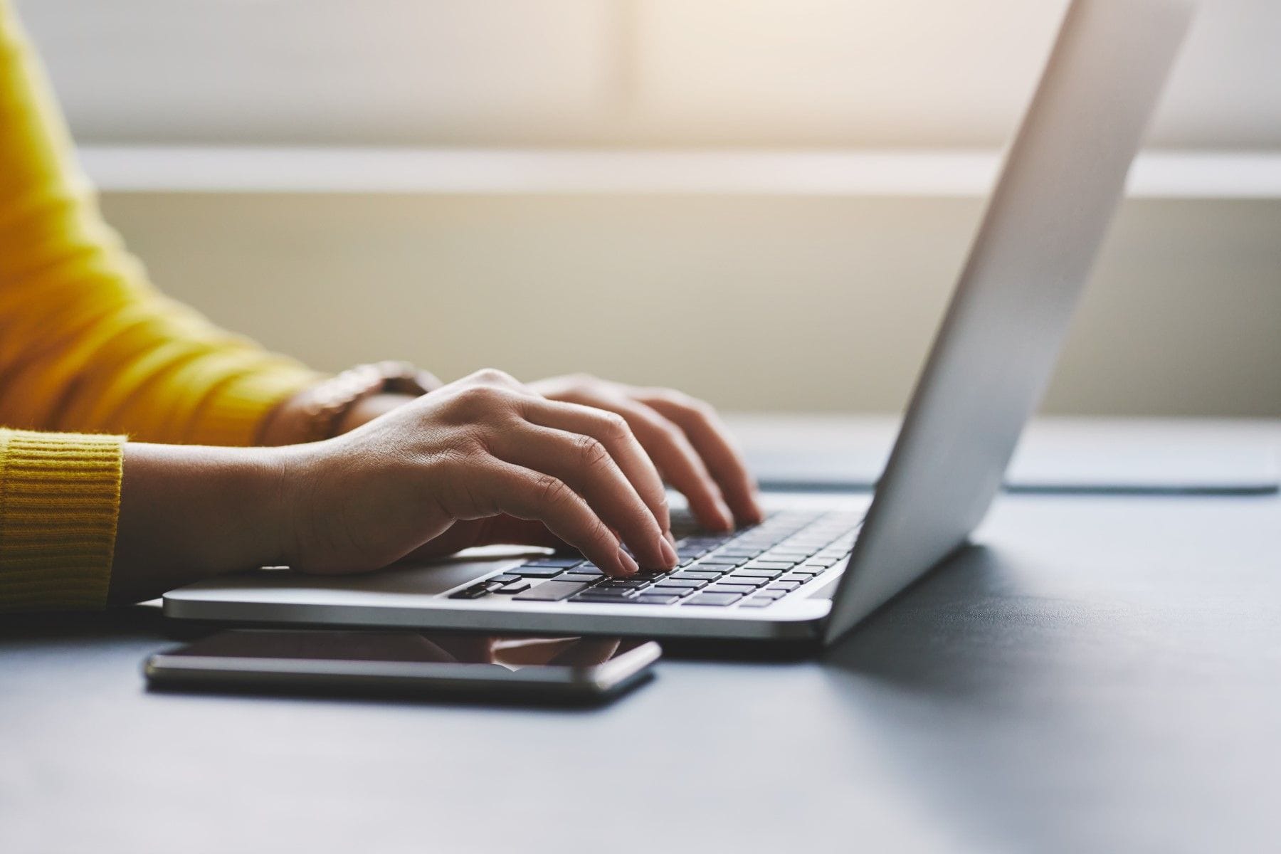 Person typing on laptop computer