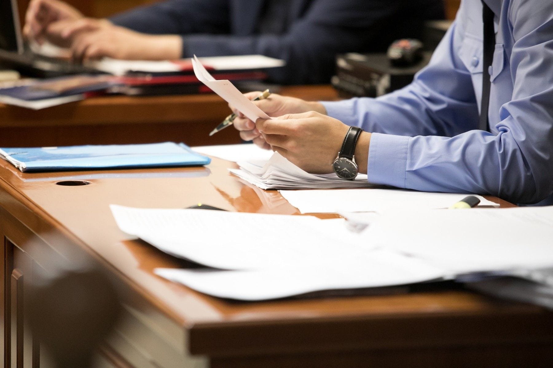attorney analyzing documents in courtroom
