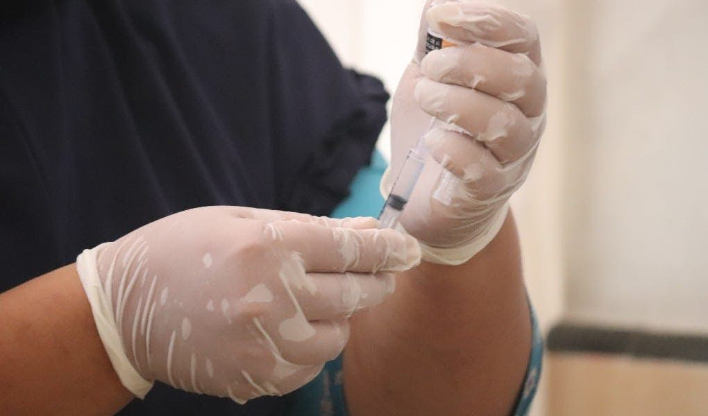physician holding shot to be injected
