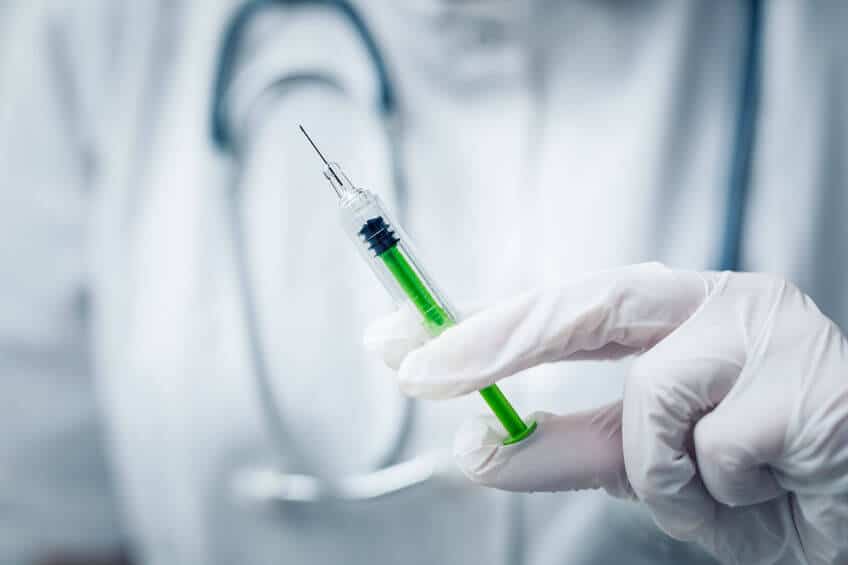 Syringe, medical injection in hand. Vaccination equipment.