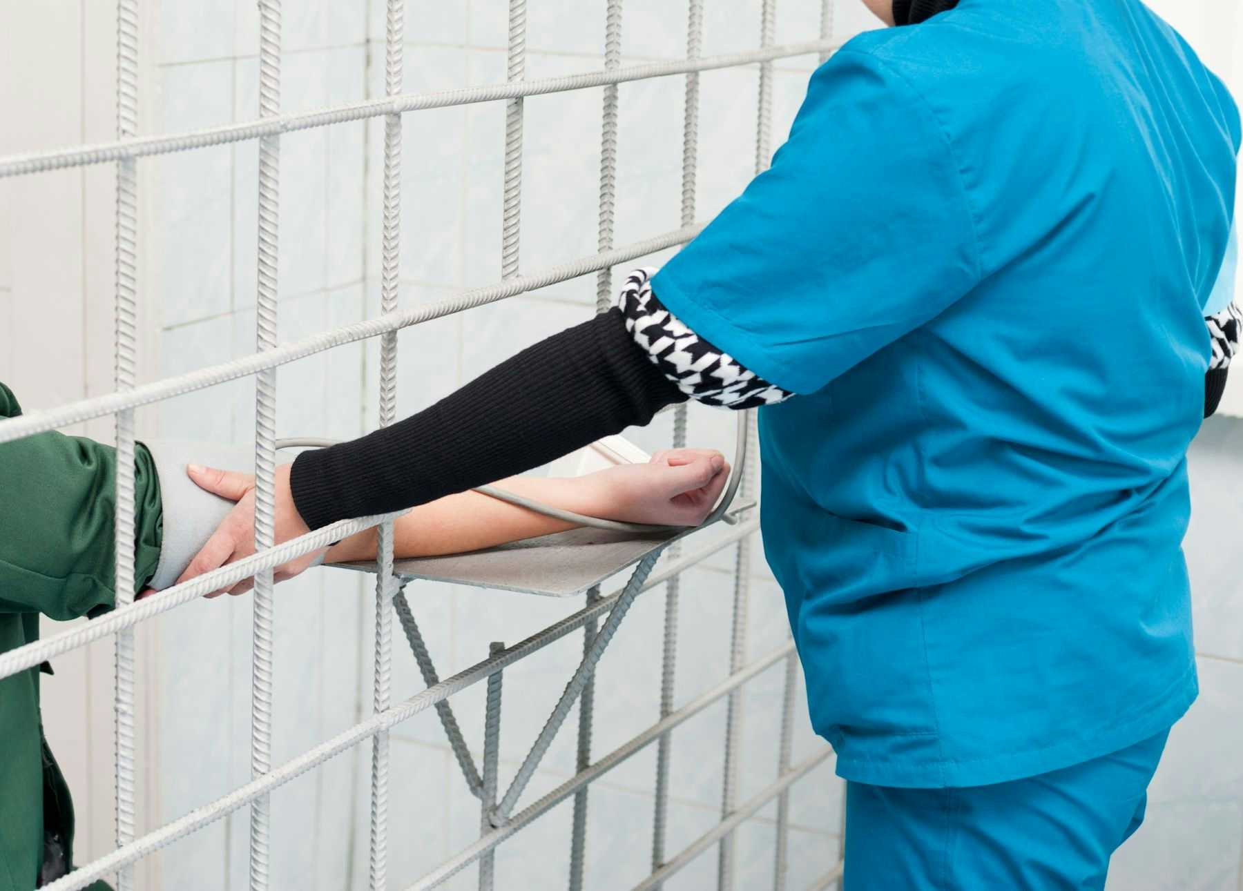 Nurse treating inmate