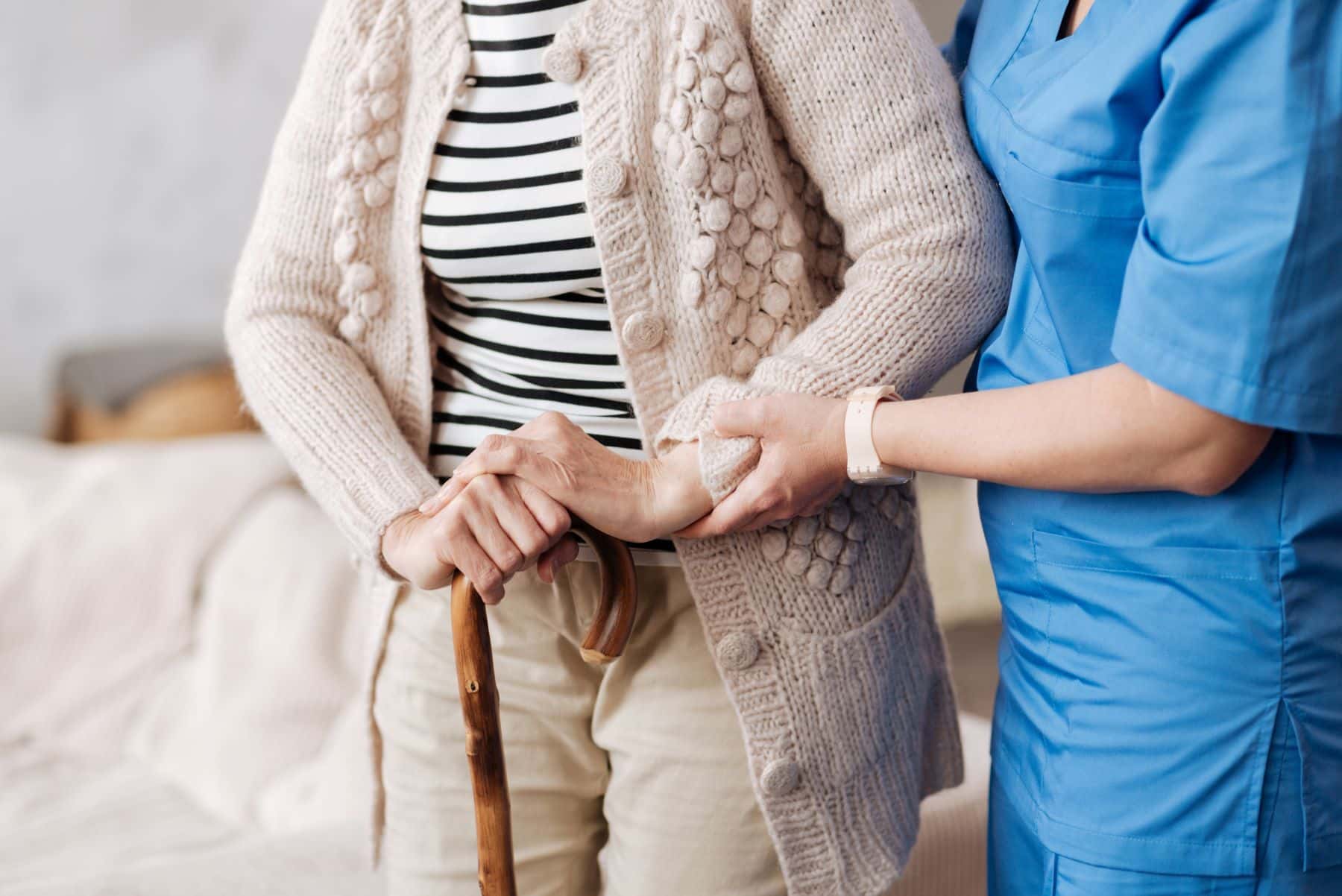 Nurse assisting elderly patient