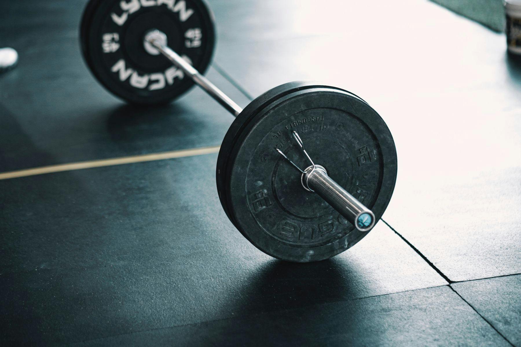 Weightlifting barbell on workout mats