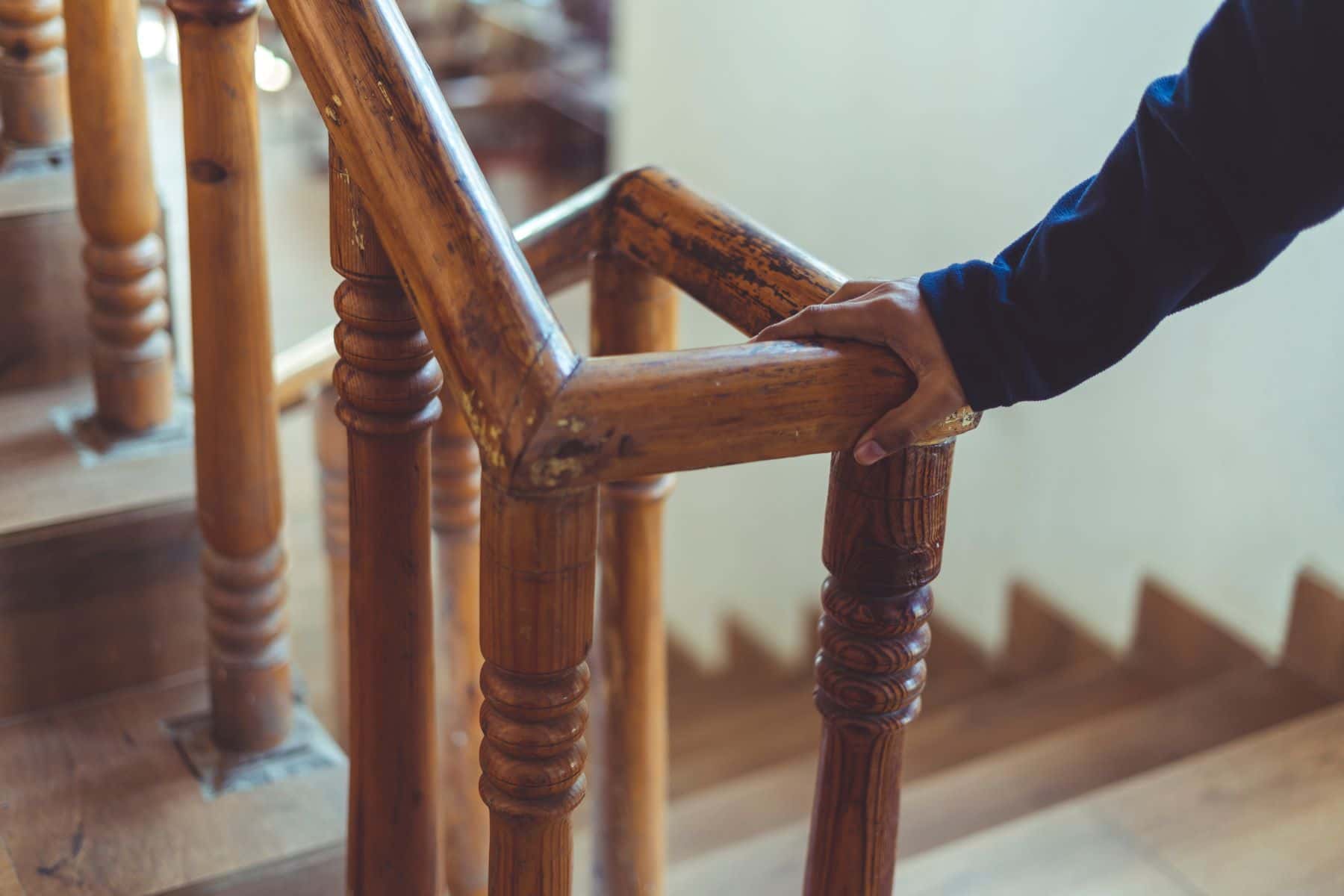 Hand on wooden railing